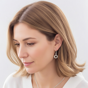 Woman wearing petite sterling silver love knot leverback dangle earrings